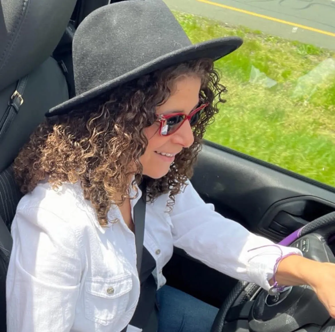 Dawnmarie smiling in her Jeep